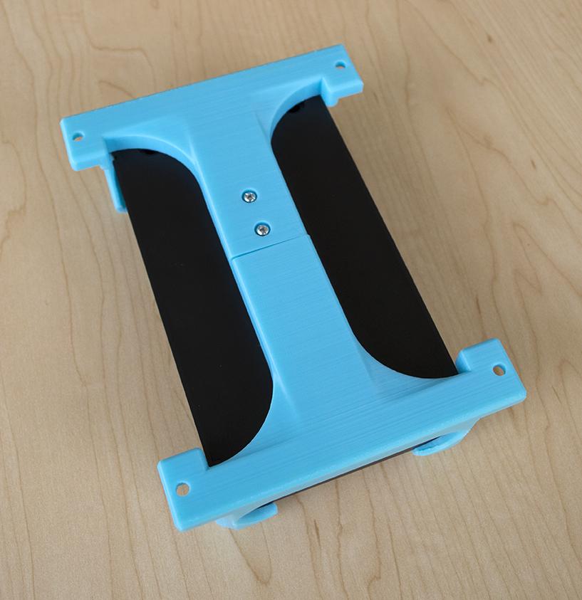 The back of the Plugable PS2-USB4 powerstrip's 3D-printed mounting bracket