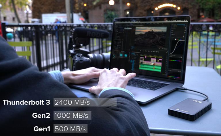 Image of the Plugable Solid State Drive connected to a laptop being used for video editing