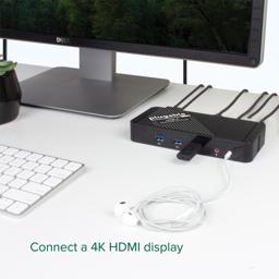 Thumbnail of Image of the Plugable USB-C Docking Station flat on a desk, connected to a USB drive and headphnoes, connecting to a 4K display